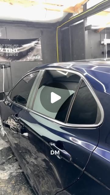 Dark blue sedan with fresh window tint in the studio